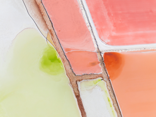 Aerial view of levee banks dividing colourful salt evaporation ponds - Australian Stock Image