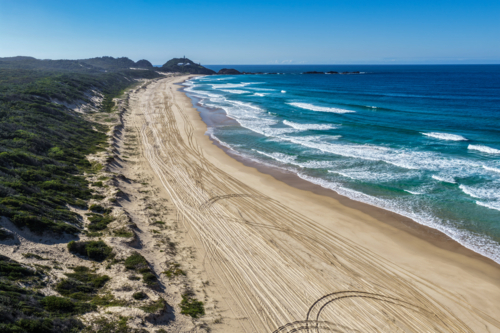 Aerial view of Lighthouse Beach leading towards the historic Seal Rocks Lighthouse - Australian Stock Image