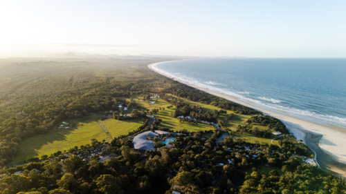 Aerial view of long stretch of white sand beach to distant horizon - Australian Stock Image