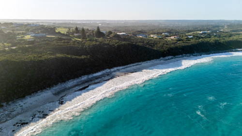Aerial view of long stretched white sand beach with turquoise water - Australian Stock Image