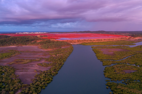 Aerial view of mangroves and industrial red soil - Australian Stock Image