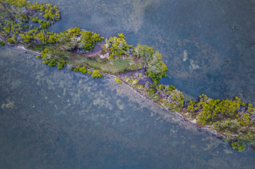 Aerial view of Ohmas Bay in Tuncurry, capturing its calm turquoise waters - Australian Stock Image