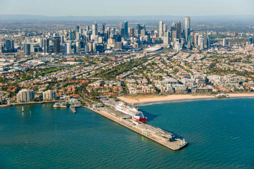 Aerial view of Port Melbourne with the Spirit of Tasmania docked and the city skyline - Australian Stock Image