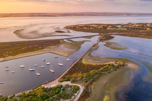 Aerial view of roads joining islands in a coastal bay at sunsets - Australian Stock Image
