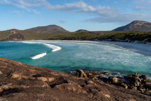 Aerial view of rocky terrain on the coast with turquoise water - Australian Stock Image