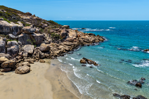 aerial view of Rose Bay in Bowen, Queensland, showcasing turquoise waters and rocky headland - Australian Stock Image