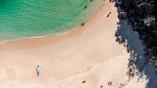 Aerial View of Secluded Beach Cove with Clear Turquoise Water and kayak - Australian Stock Image