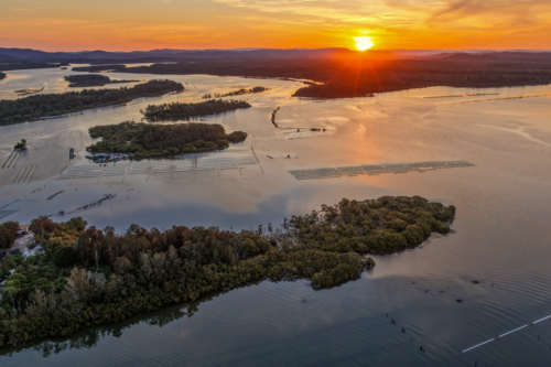 aerial view of sunset over the river and small islands at Tuncurry - Australian Stock Image