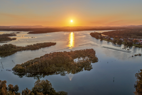 aerial view of sunset over the river and small islands at Tuncurry - Australian Stock Image