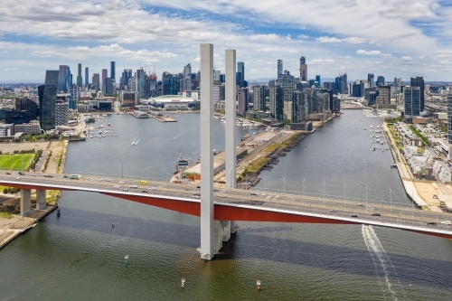 Aerial view of the Bolte Bridge over the Yarra River and Melbourne city skyline in the background - Australian Stock Image