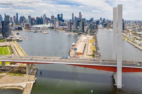 Aerial view of the Bolte Bridge over the Yarra River and Melbourne city skyline in the background - Australian Stock Image