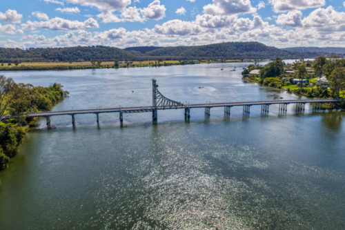 Aerial view of the bridge crossing the Clarence River at Maclean, showing the broad river - Australian Stock Image