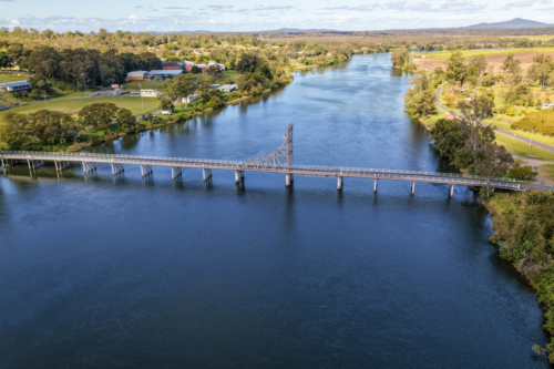 Aerial view of the bridge crossing the Clarence River at Maclean, showing the broad river, transport - Australian Stock Image