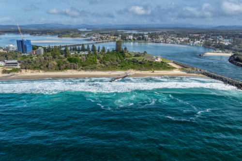 Aerial view of the Forster and Tuncurry breakwalls with the bridge spanning Wallis Lake - Australian Stock Image