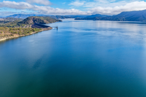 Aerial view of the Glenbawn Dam wall and surrounding landscape showcasing the expanse of the dam - Australian Stock Image