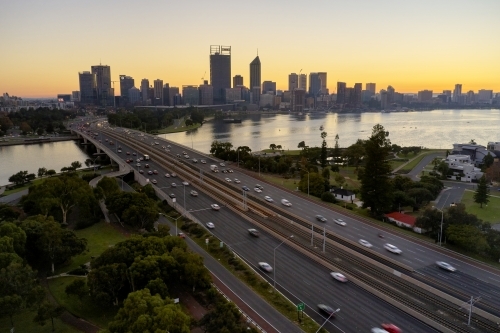 Aerial view of the Perth City skyline and Narrows Bridge at dawn on a peaceful morning. - Australian Stock Image