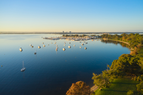 Aerial view of the Swan River in Perth with yachts and boats on the still water - Australian Stock Image