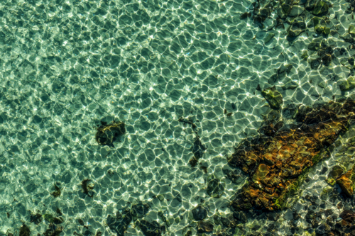Aerial view of The Tanks in Forster, showcasing the iconic rock formations and clear waters - Australian Stock Image