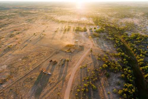 Aerial view of Tobermorey Station at sunrise, casting long shadows across the arid outback. - Australian Stock Image