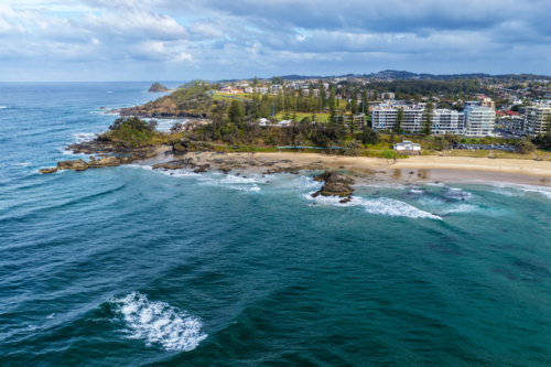 Aerial view of Town Beach and the rocky headland at Port Macquarie, showcasing the coastline - Australian Stock Image