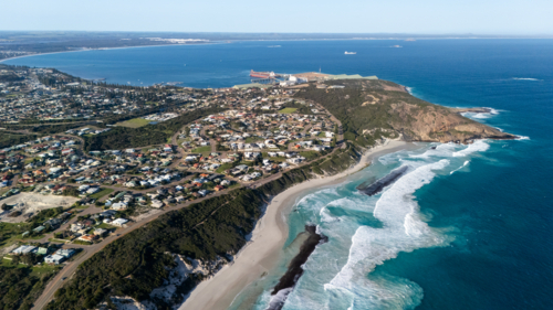 Aerial view of town on the headland along the coast - Australian Stock Image