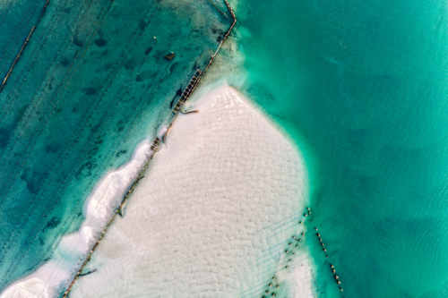 Aerial view of Wallis Lake at low tide, revealing intricate sand patterns - Australian Stock Image