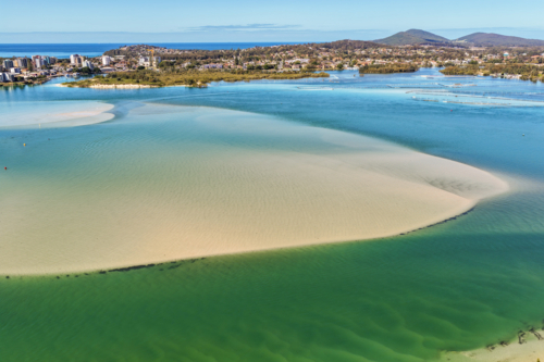 Aerial view of Wallis Lake at low tide, revealing intricate sand patterns - Australian Stock Image