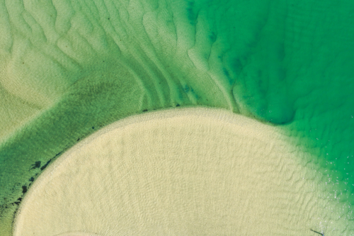 Aerial view of Wallis Lake at low tide, revealing intricate sand patterns - Australian Stock Image