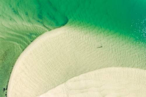 Aerial view of Wallis Lake at low tide, revealing intricate sand patterns - Australian Stock Image