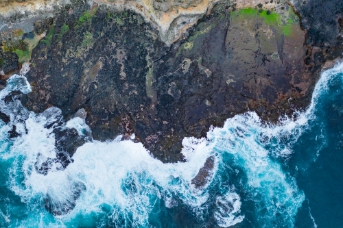 Aerial view of waves crashing on a rugged coastline