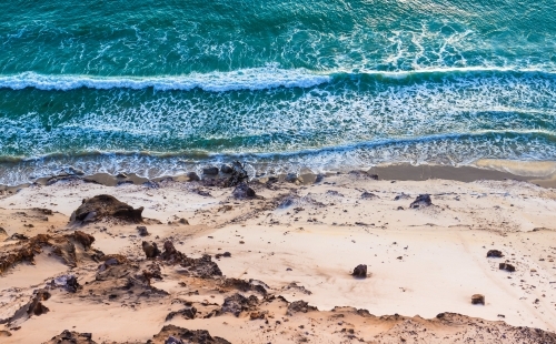 Aerial view of waves crashing on beach - Australian Stock Image