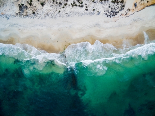 aerial view of waves washing up onto a beach - Australian Stock Image