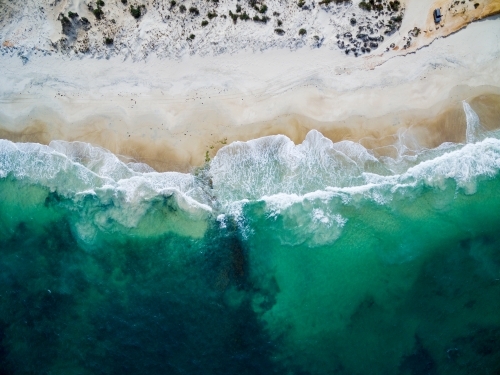 aerial view of waves washing up onto a beach