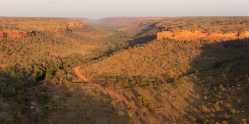 Aerial view of winding dirt road through escarpment in the Northern Territory - Australian Stock Image