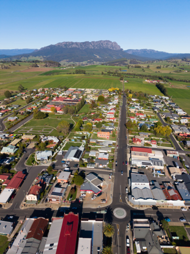 Aerial view over the town of Sheffield in Tasmania, Mt Roland appearing in the distance - Australian Stock Image