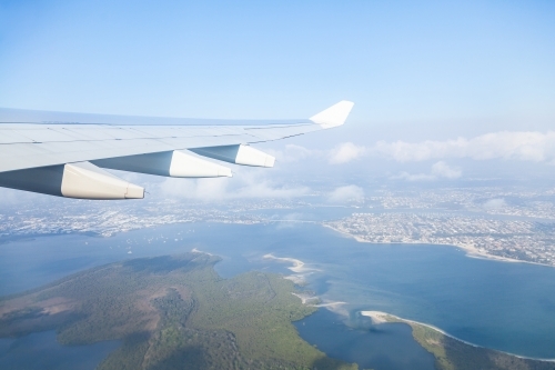 Aeroplane wing view over Sydney after takeoff - Australian Stock Image