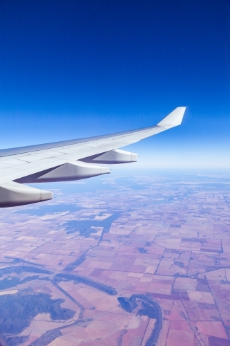 Aeroplane wing with brown australian farmland below - Australian Stock Image