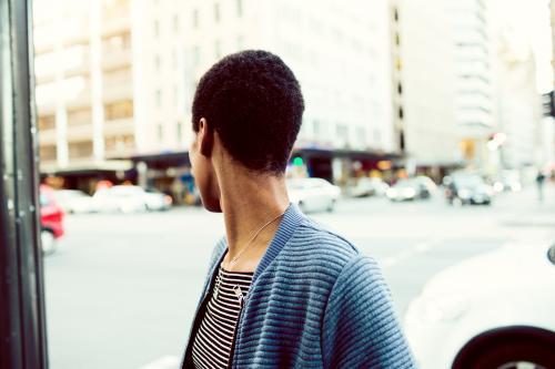 African woman looking over her shoulder in the street - Australian Stock Image