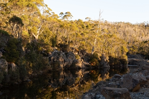 Afternoon sun reflections on creek bed - Australian Stock Image