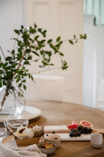 Afternoon tea with blueberry muffins and grapes and grapefruits - Australian Stock Image