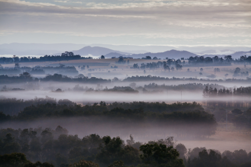 An aerial view across a valley at sunrise in the Hunter Valley, New South Wales, Australia - Australian Stock Image