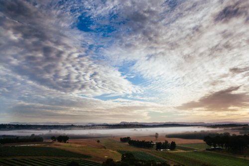 An aerial view across a valley at sunrise in the Hunter Valley, New South Wales, Australia - Australian Stock Image