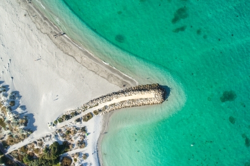 An aerial view of a groin leading out into water - Australian Stock Image