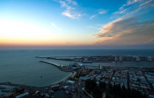 An aerial view of a port city at sunset - Australian Stock Image