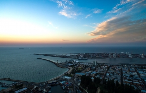An aerial view of a port city at sunset