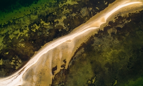 An aerial view of a sandbank partially covered by water