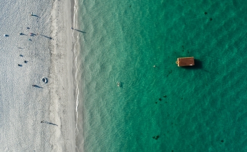 An aerial view of people walking on a beach - Australian Stock Image