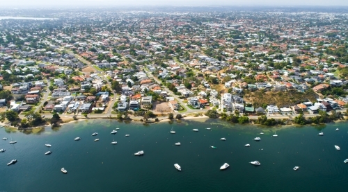 An aerial view of suburbia located near a river