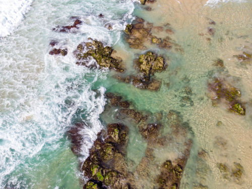 An aerial view of the coastline sea and sand on Cabarita Beach at Hastings Point in New South Wales - Australian Stock Image