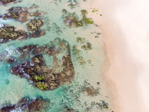 An aerial view of the coastline sea and sand on Cabarita Beach at Hastings Point in New South Wales - Australian Stock Image